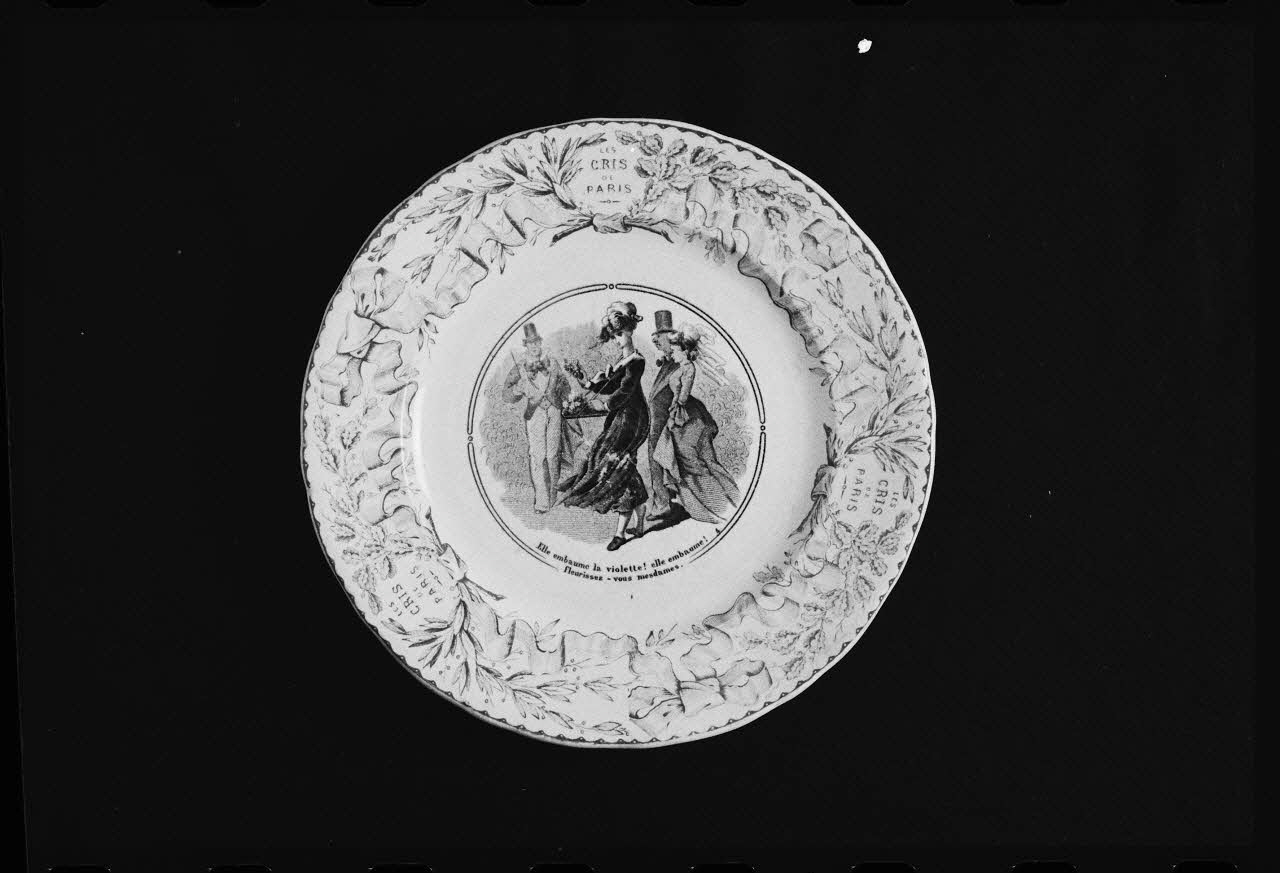photographie Assiette plate en faïence fine du 19è siècle avec un décor représentant un marchand de fleurs et une inscription : "Les cris de Paris" Ph.1984.1.267 Photo