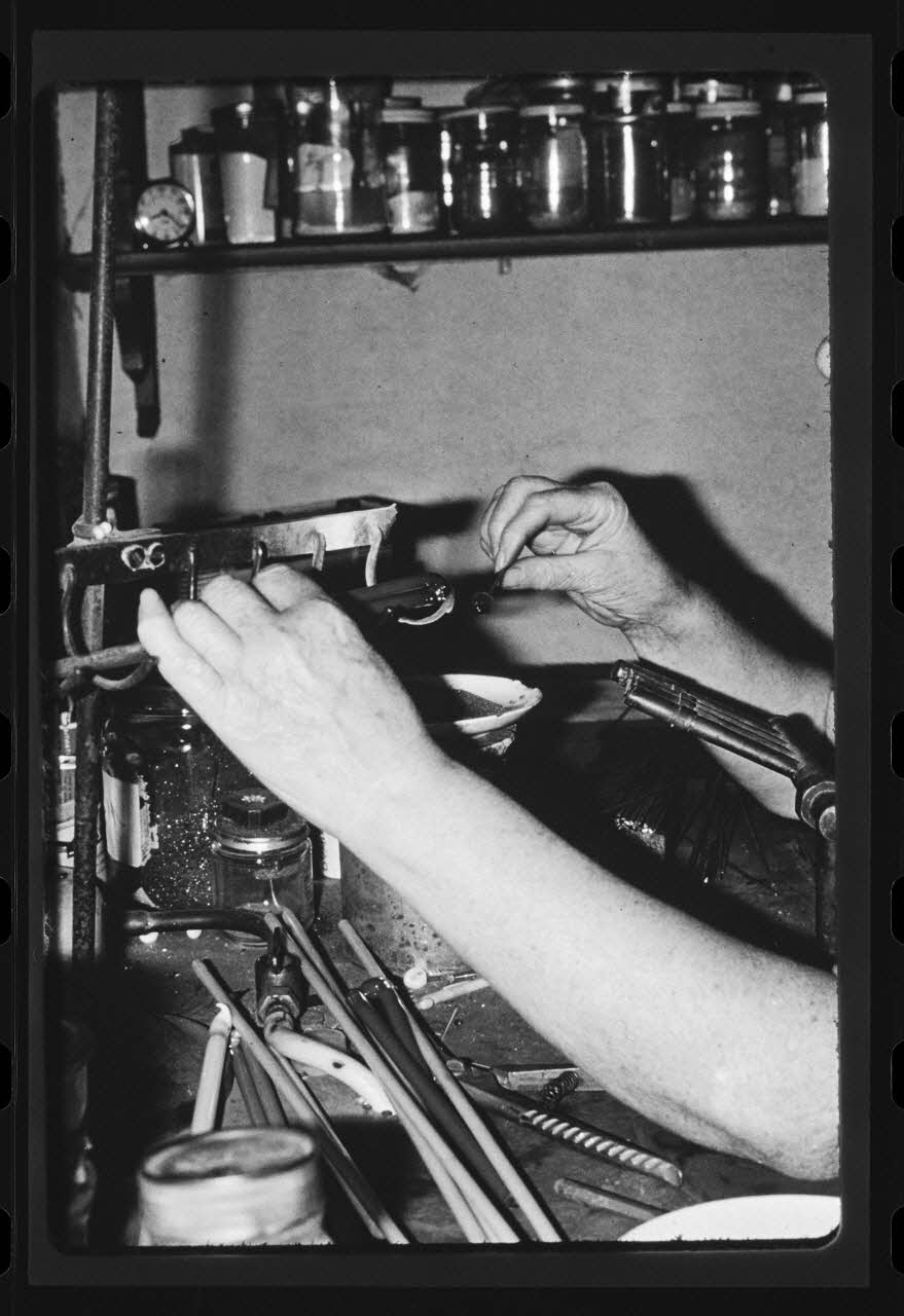 Anonyme photographie Transformation et utilisation du verre. Emailleuse en train de faire des perles artificielles Ile-de-France, France 1967 Ph.1984.27.5 Photo