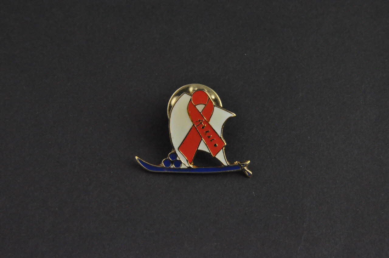 Pin's ruban rouge Pin's  ruban rouge sur voilier 2003.109.235.1-2 Photo Mucem